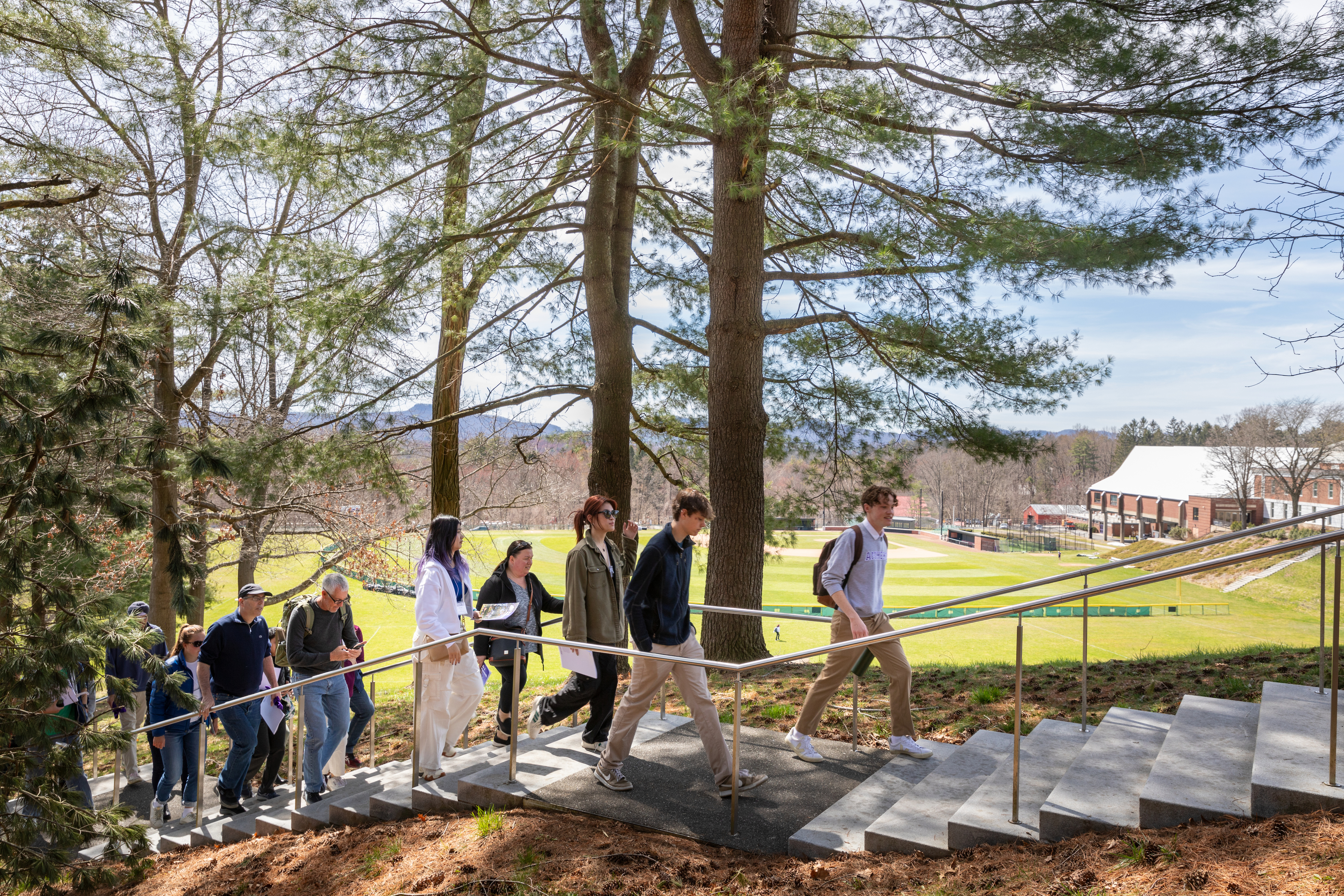Visitors to campus climb the stairs leading to the War Memorial on the Amherst College campus.