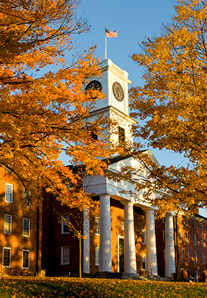 Johnson Chapel in bright sunlight surrounded by fall foliage