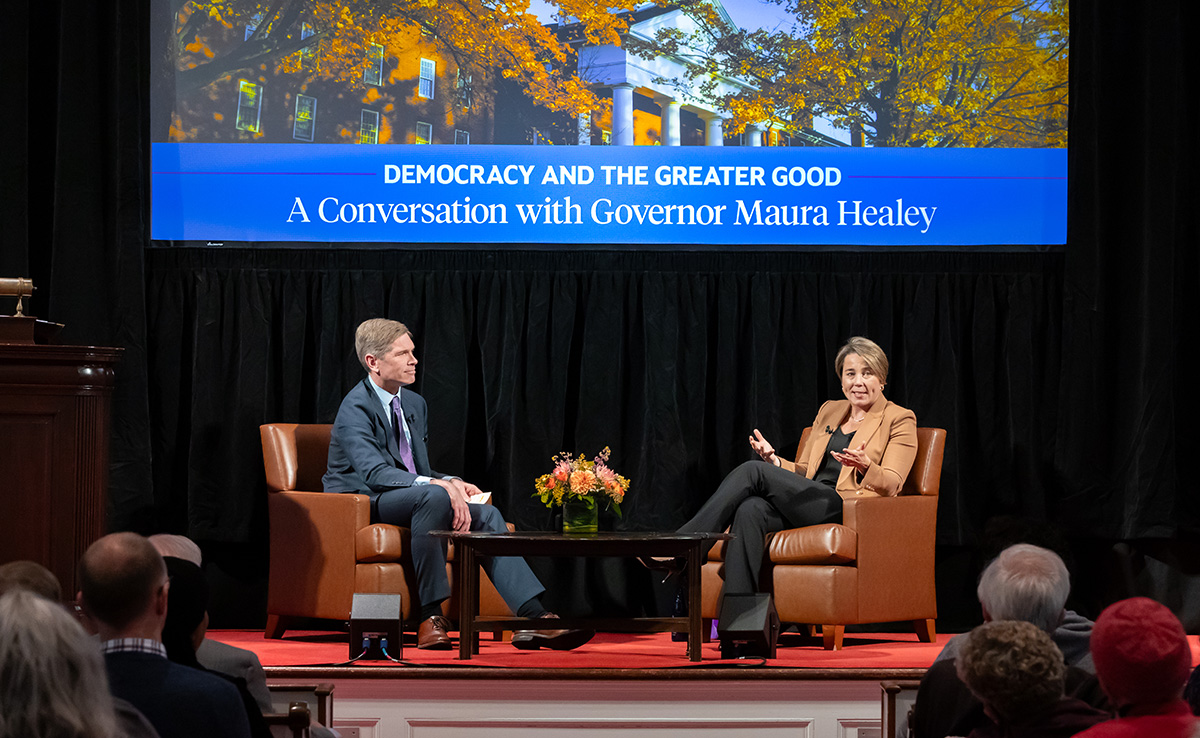 President Elliot and Governor Maura Healey speaking on a stage