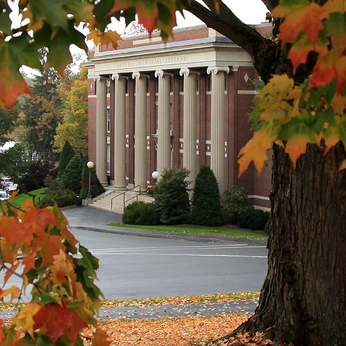 Converse Hall seen through a group of fall trees