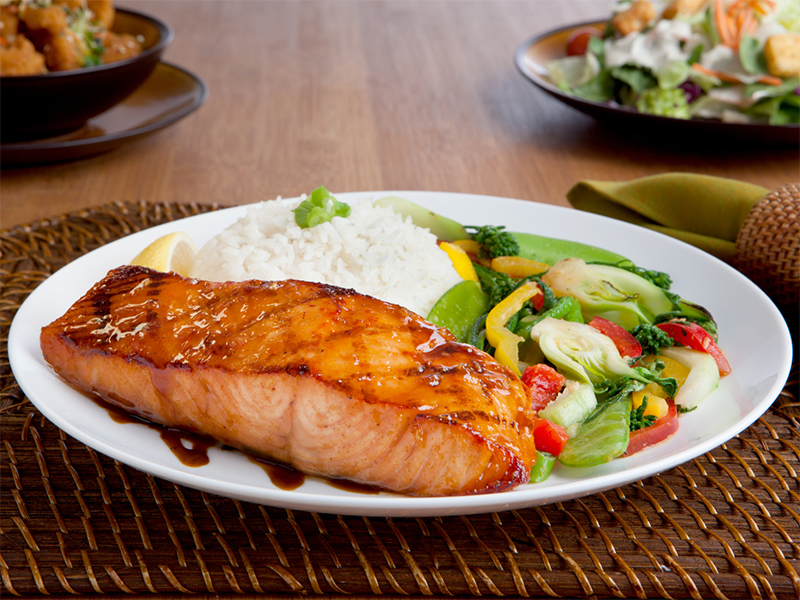 A dinner plate with salmon, rice and vegetables