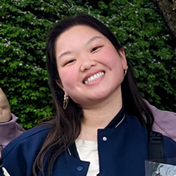 A young Asian woman smiling and tilting her head