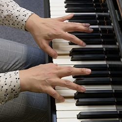 a pair of hands playing the piano