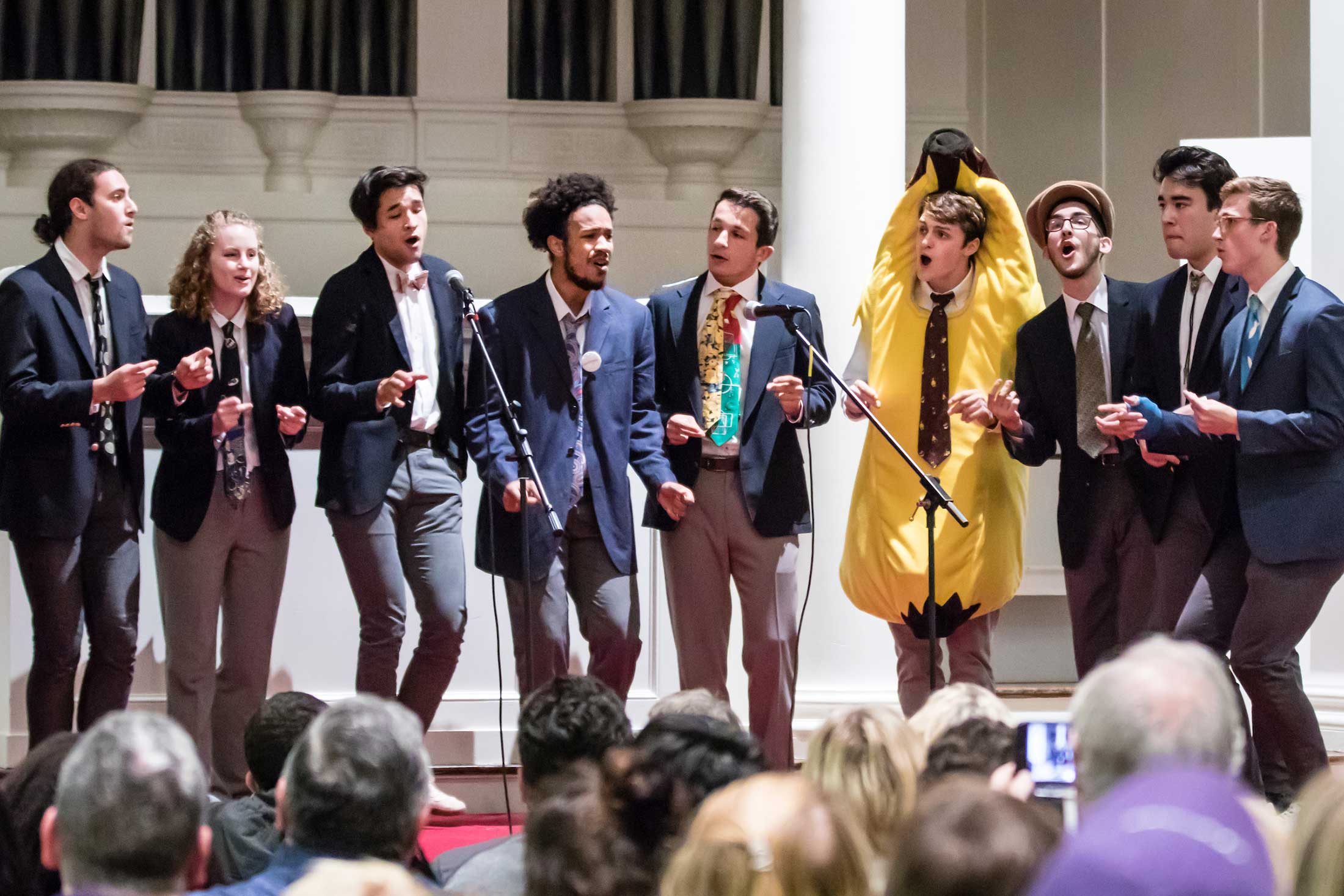 An a capella group performs (one member is dressed like a banana)