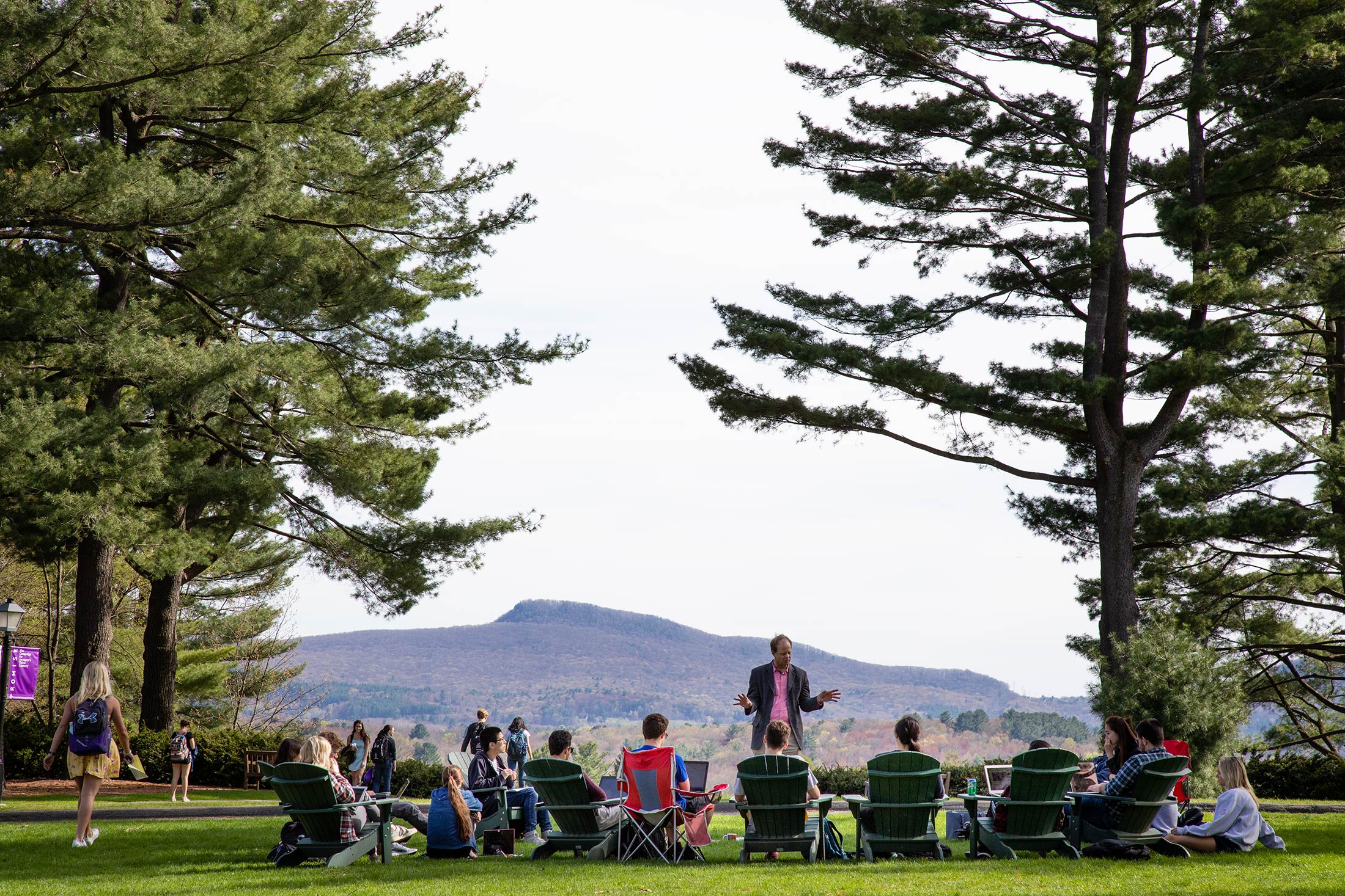 A professor holds a class outside on the academic quad