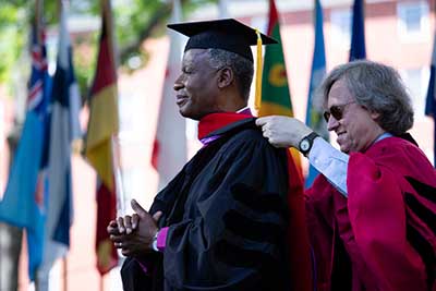 A man receiving an honorary degree during commencement.
