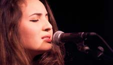 Nina Shallman ’18 at singing into microphone
