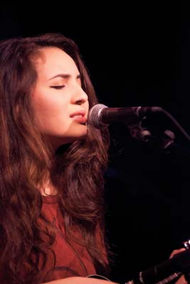 Nina Shallman ’18 at singing into microphone