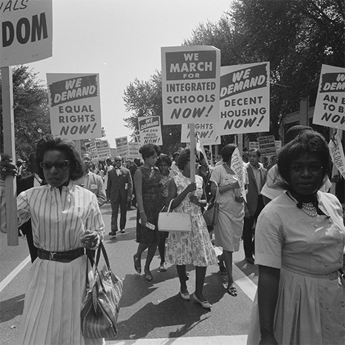 A black and white photo of Black women marching at a Civil Rights march