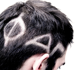 A photo of a man's head with Greek letters cut into his hair
