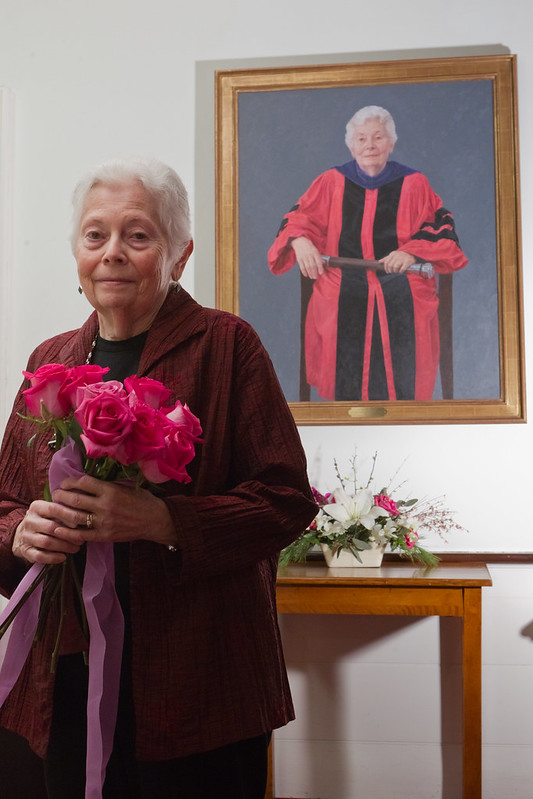 Rose Olver poses next to her painted portrait