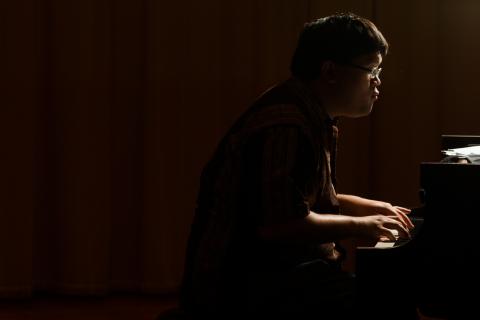 Daniel Ang '15 at piano in silhouette