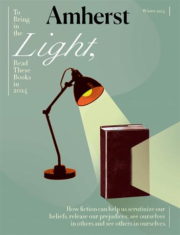 The cover of Amherst Magazine with a luxo lamp shining on a book.