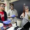 Professor Patricia OHara performing a chemistry experiment with two students